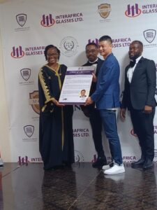 The MD of INTER AFRICA GLASSES LTD, the main sponsor of the event receiving a citation of appreciation, presented by Rector